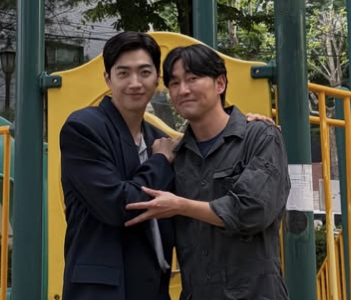 Kang Hoon e Heo Joon-seok abraçados num parquinho, nos bastidores de Meu Idol é Meu Chefe