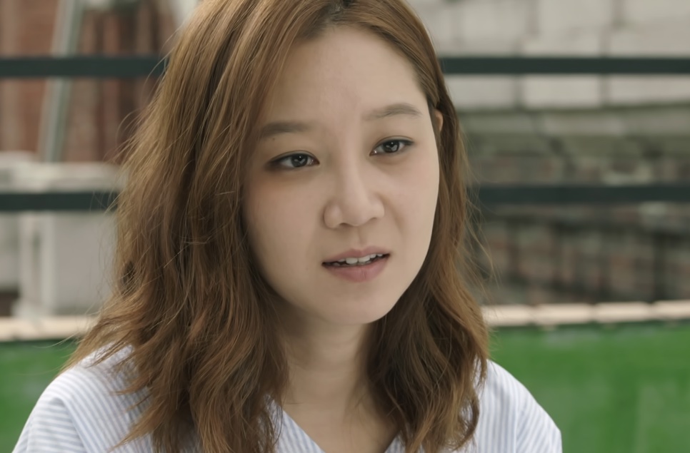 Gong Hyo-jin, no papel de Tae Gong-shil em Sol do Mestre, de camiseta listrada, falando ao ar livre