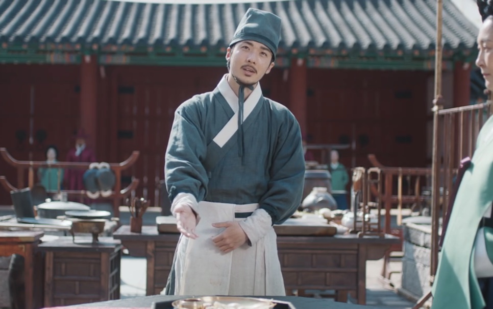 Maeng Man-su de avental, falando no pátio da cozinha do palácio em Bon Appétit, Vossa Majestade